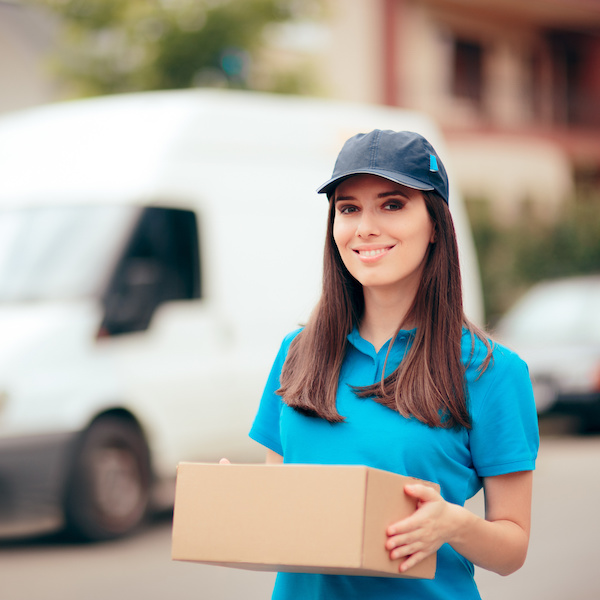 106487482 - delivery worker holding cardboard box package